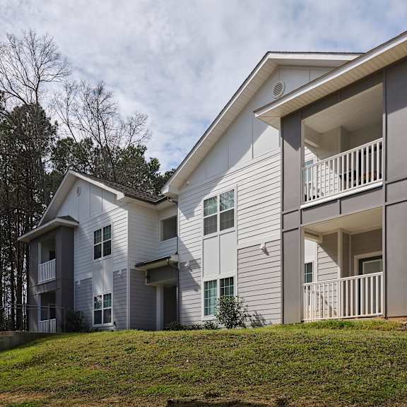 a modern two-story house with a balcony on the upper floor.