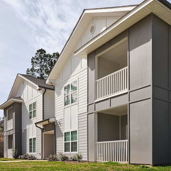 a modern two-story apartment building with balconies.