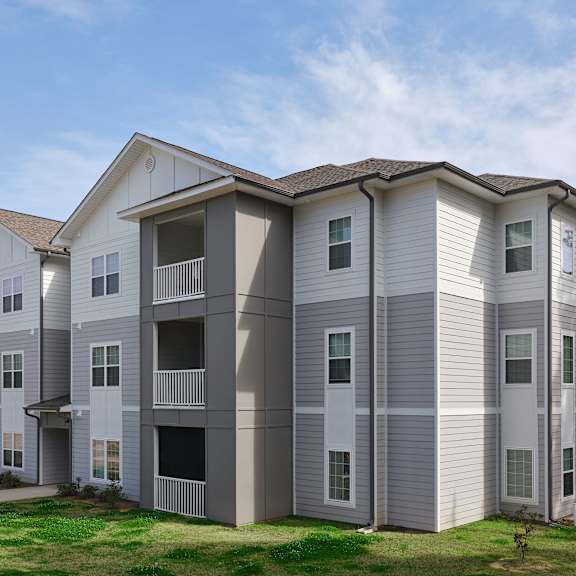 a large apartment building with multiple balconies and windows.