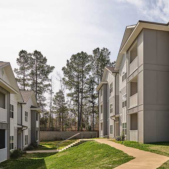 apartment complex with a walkway in the foreground.