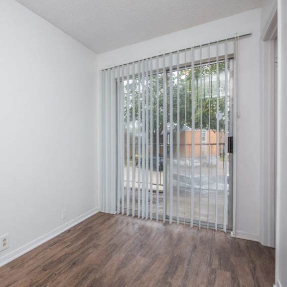 the living room has a large window and wood flooring