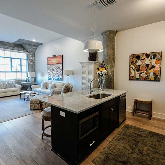 a kitchen with a black fridge and a white counter top.