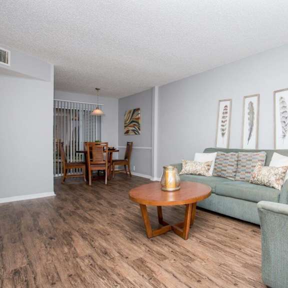 a living room and dining room with couches and a table