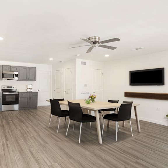 a modern kitchen with a dining table set up.