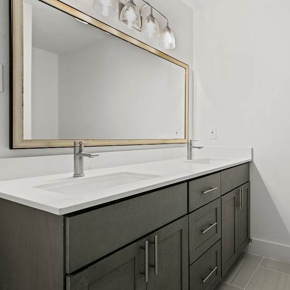 a bathroom with a sink and a mirror above it.