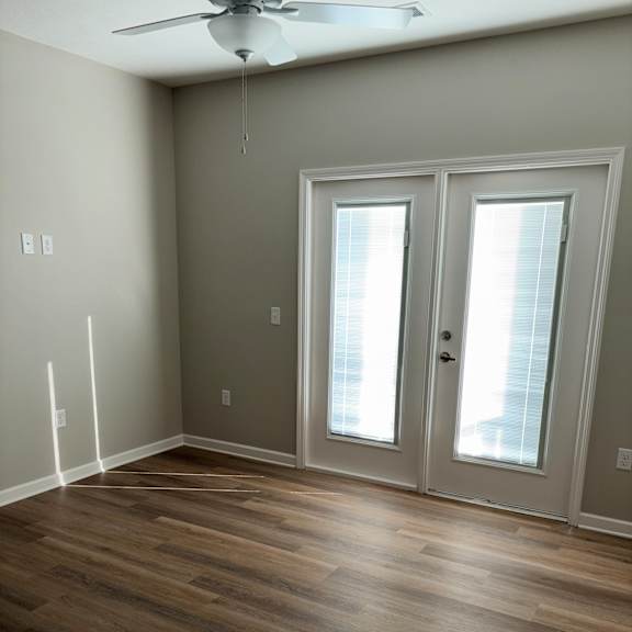 a room with a window and a wooden wall.