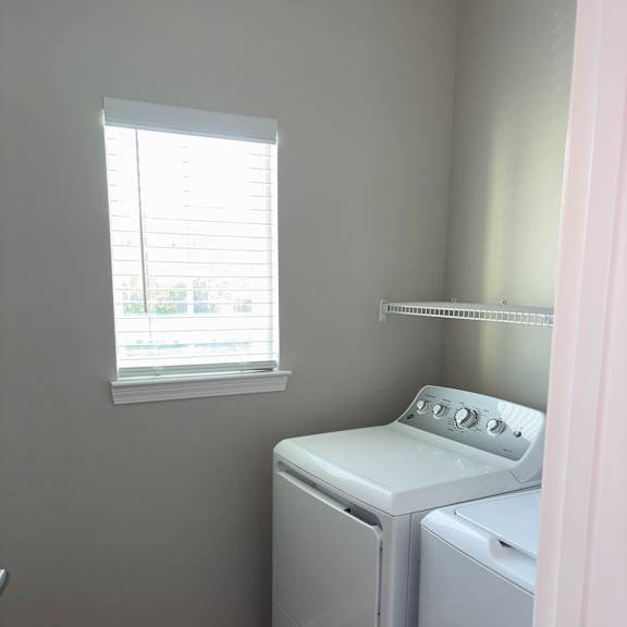 a white oven is installed in a kitchen with a window.