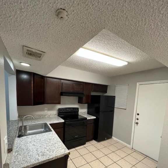 a kitchen with a sink and a stove and