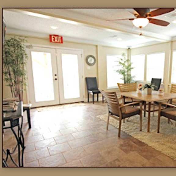 a dining room with a table and chairs.