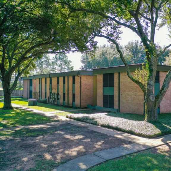a building with a green lawn in front of it.