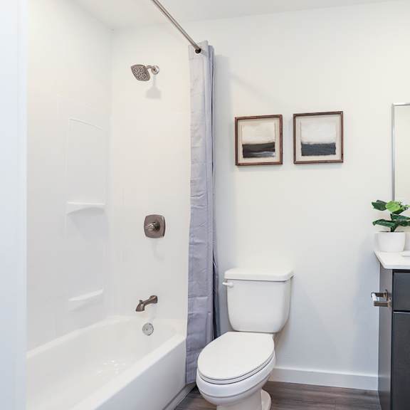 a white toilet sits next to a white sink in a bathroom.