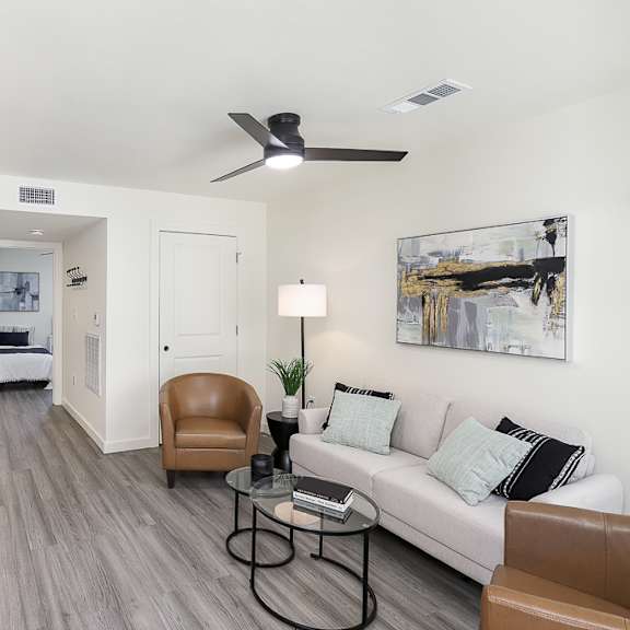 a living room with a brown chair and a white couch.