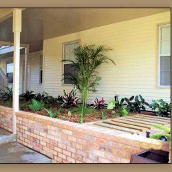 a house with a staircase and a wall of plants.