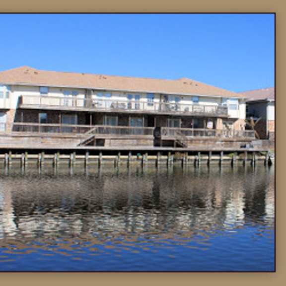 a building is situated on a dock over water.