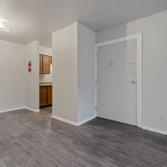 a room with a grey floor and white walls.