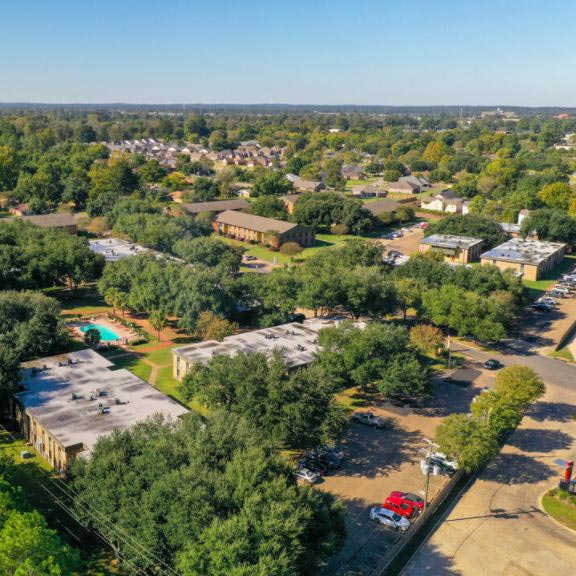 a bird's eye view of a green campus with buildings and trees.