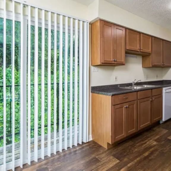 a kitchen with wooden cabinets and a white refrigerator.