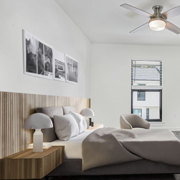 a bedroom with a large bed and a ceiling fan.
