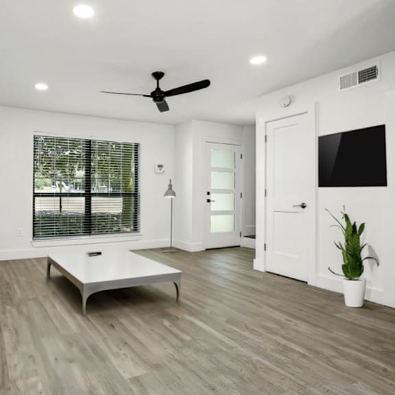 a living room with a brown sofa and a white coffee table.