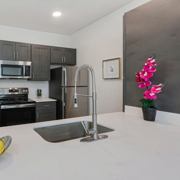a kitchen with a bowl of lemons on the counter.