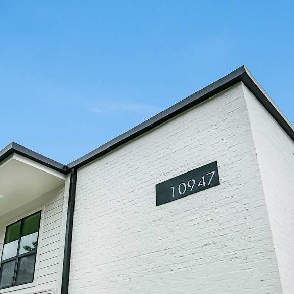 a white house with the number 10947 on the wall.
