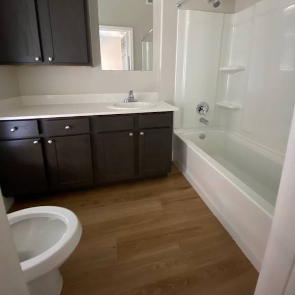 an empty bathroom with a toilet sink and tub
