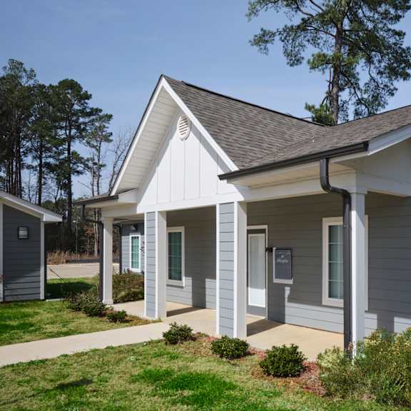 a small house with a grey and white exterior.