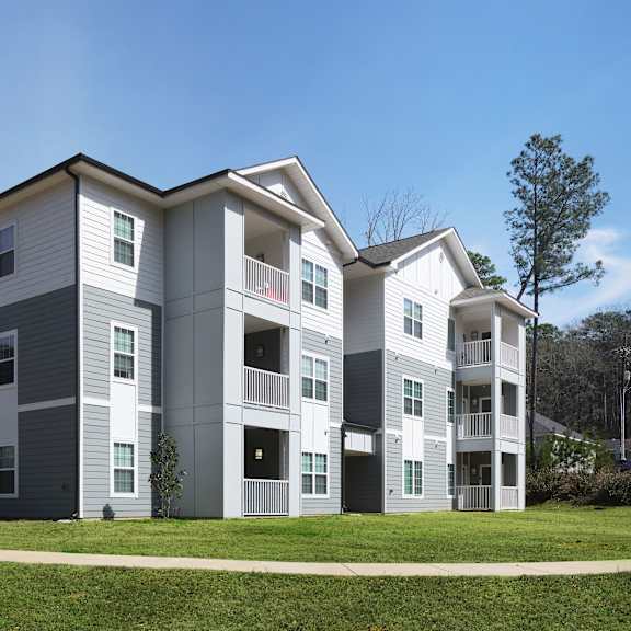 a modern apartment building with balconies and multiple stories.