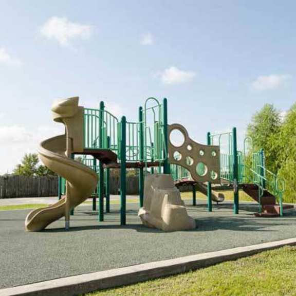 a playground with a slide, swings, and a climbing frame.