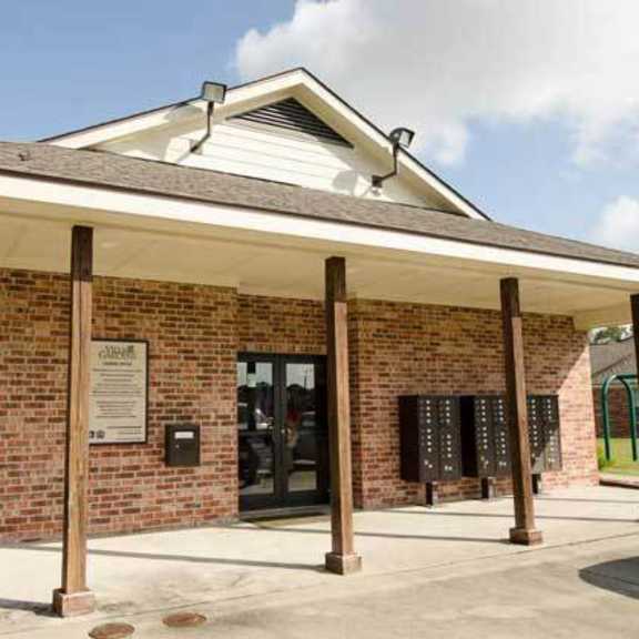 a small building with a brick wall and a sign on it.
