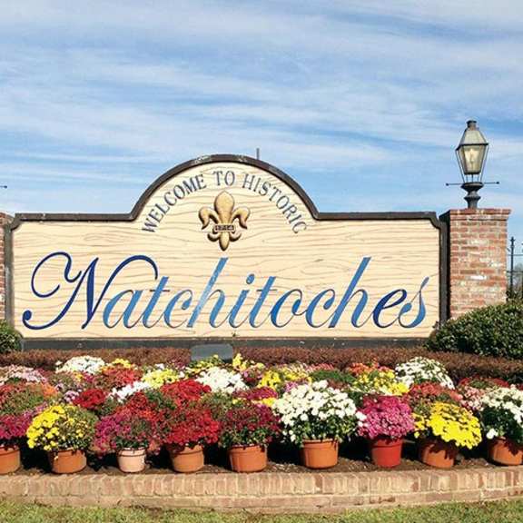 a sign that says natchitoches surrounded by flowers.