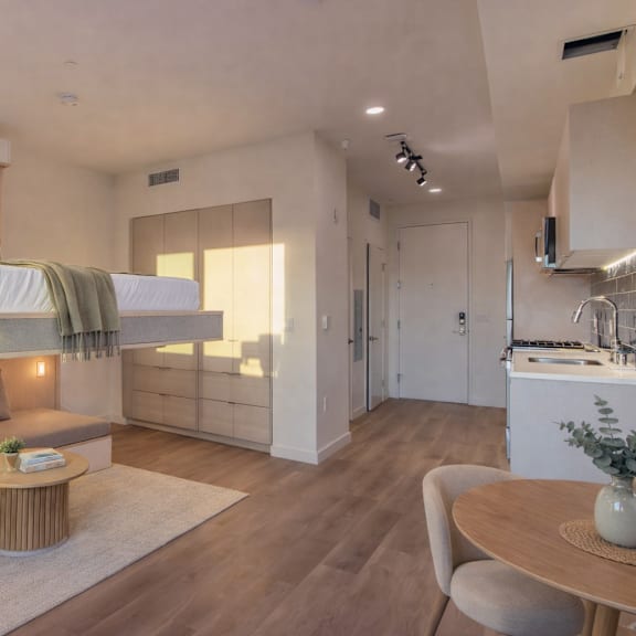 a modern bedroom with a built-in bed and a seating area.
