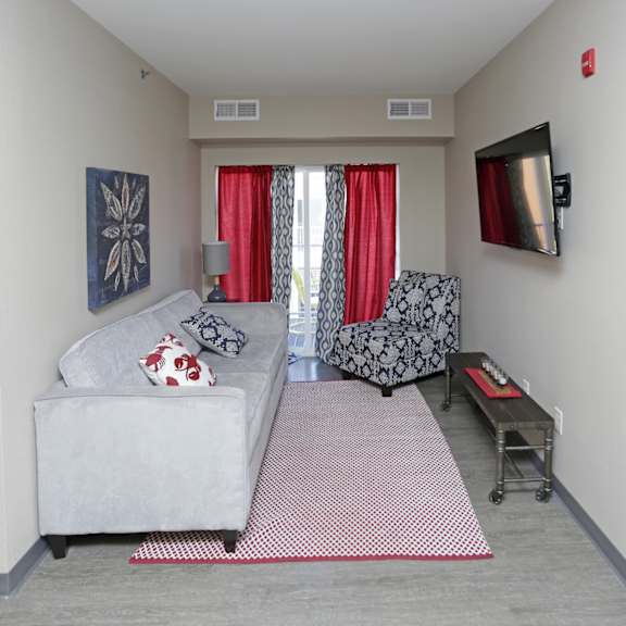 a living room filled with furniture and a flat screen tv
