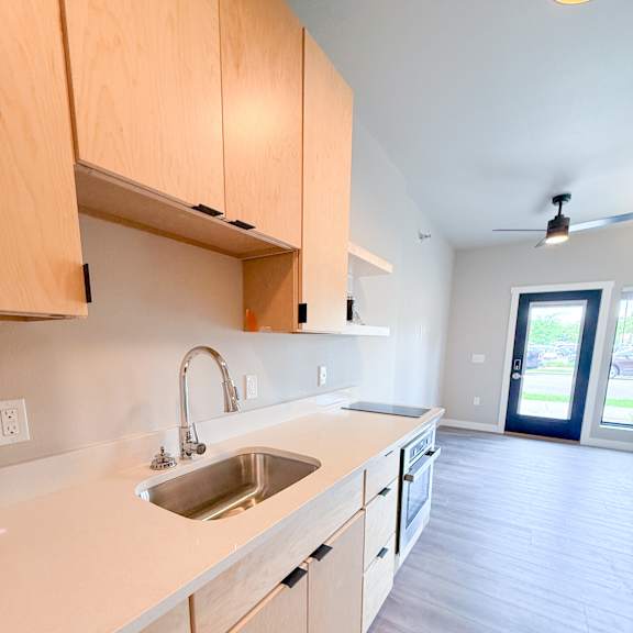 a kitchen with wooden cabinets and a sink.
