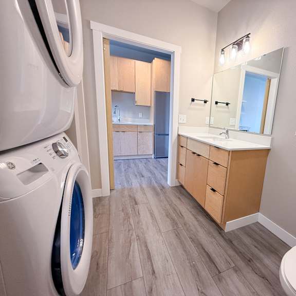 a bathroom with a washer and dryer in the corner.