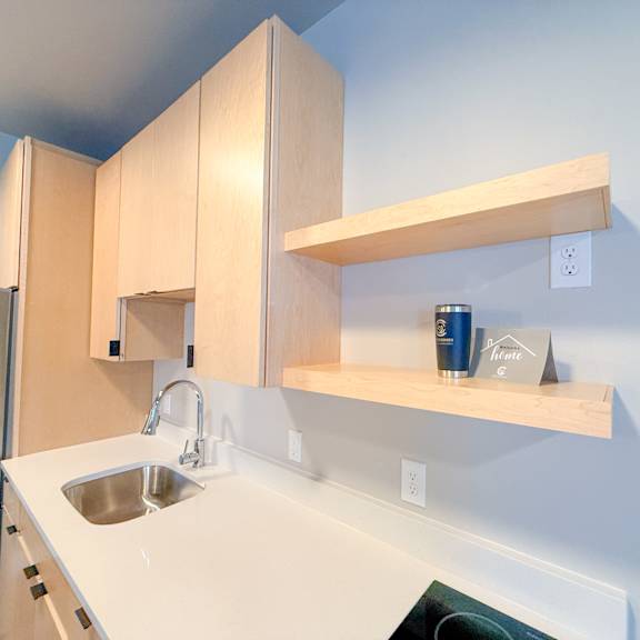 a kitchen with a sink and a refrigerator.