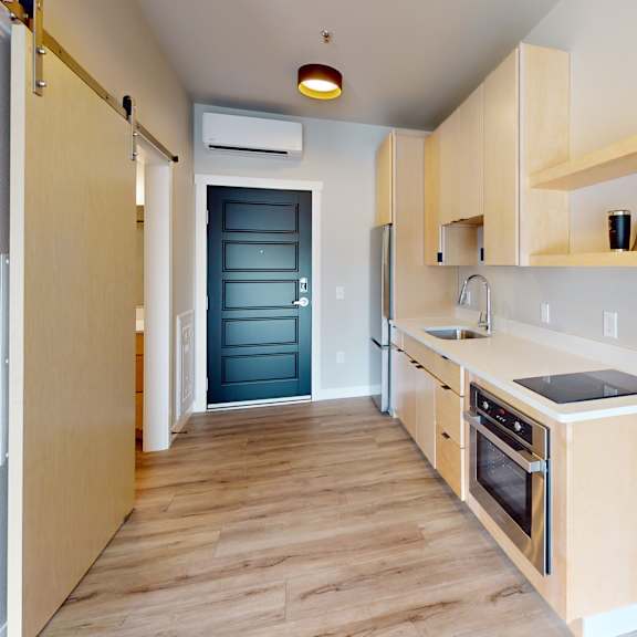 a kitchen with wooden floors and cabinets.