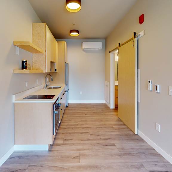 a kitchen area with a sink and cabinets.