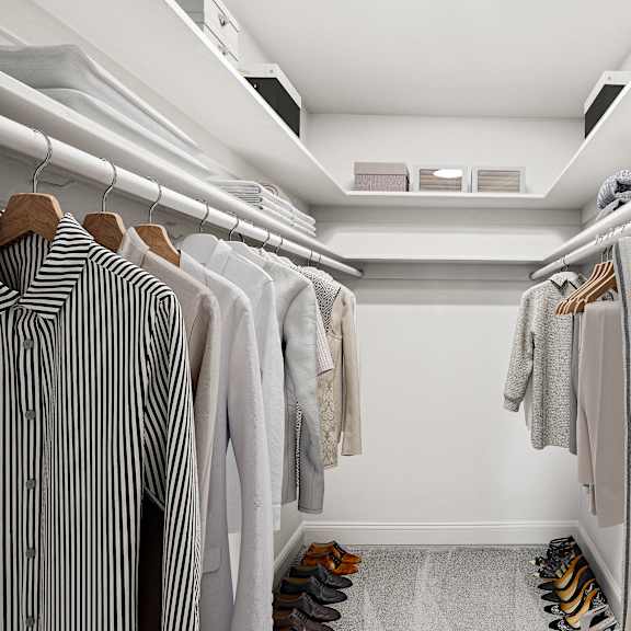 Thumbnail 10 of 13 a walk in closet filled with clothes and shoes