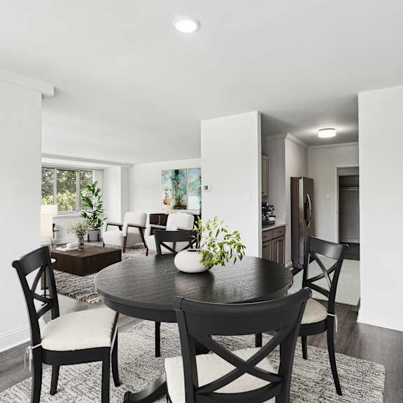 Thumbnail 4 of 13 a dining room with a table and chairs
