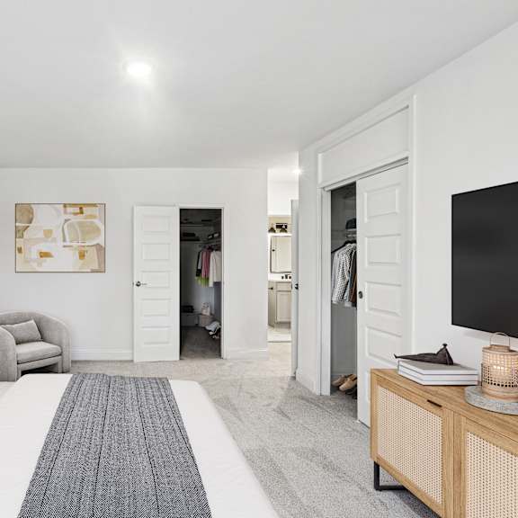 Thumbnail 8 of 13 a bedroom with a large bed and a tv