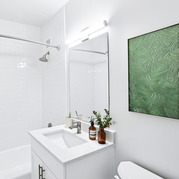 Thumbnail 7 of 7 a white bathroom with a shower and a sink