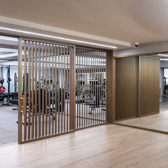 a room with wooden floors and a large mirror on the wall.