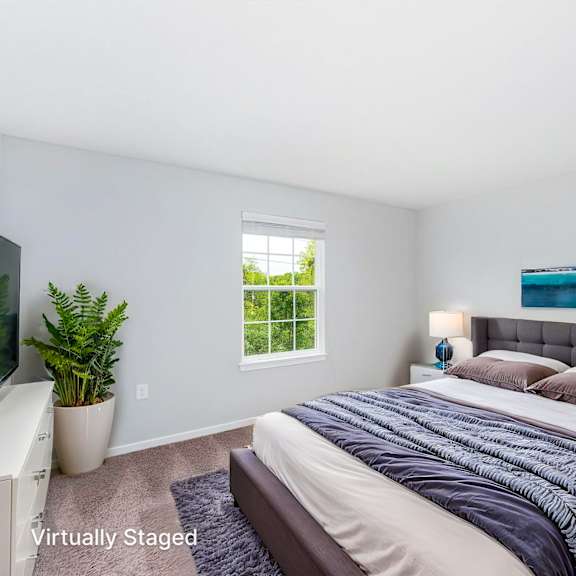 a bedroom with a large bed and a window.