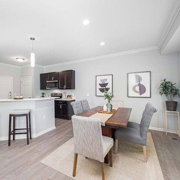 a dining room and kitchen with a table and chairs
