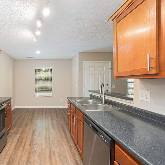 a kitchen with stainless steel appliances and wooden cabinets