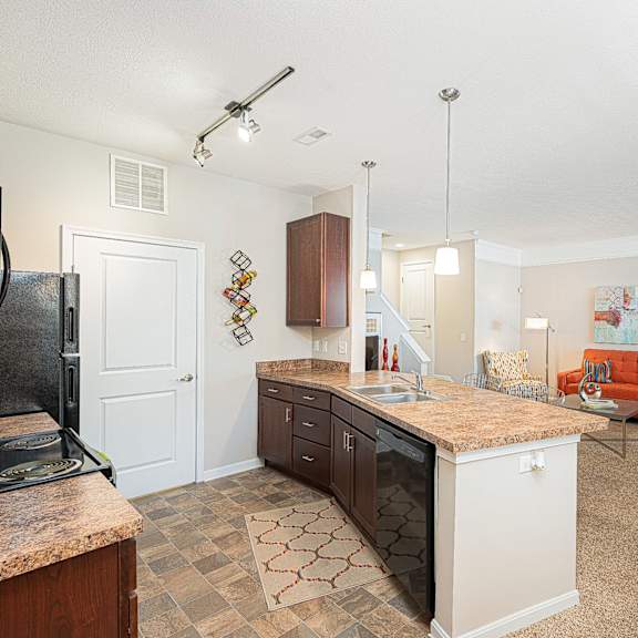 an open kitchen and living room with a counter top