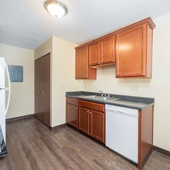 a kitchen with wooden cabinets and a white appliances