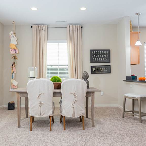 a dining room with a table and chairs.