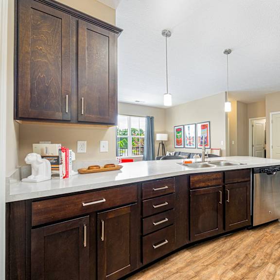a kitchen with wooden cabinets and a white counter top